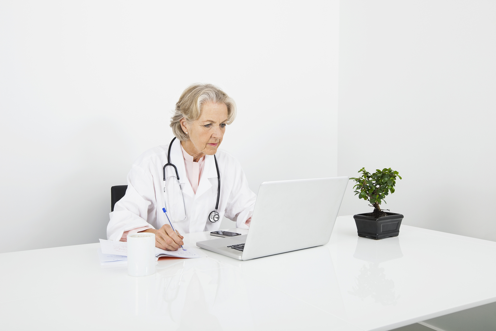 01 18 19 bigstock senior female doctor writing n 55418489