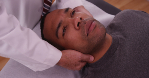 Bigstock chiropractor checking neck inj 143862290