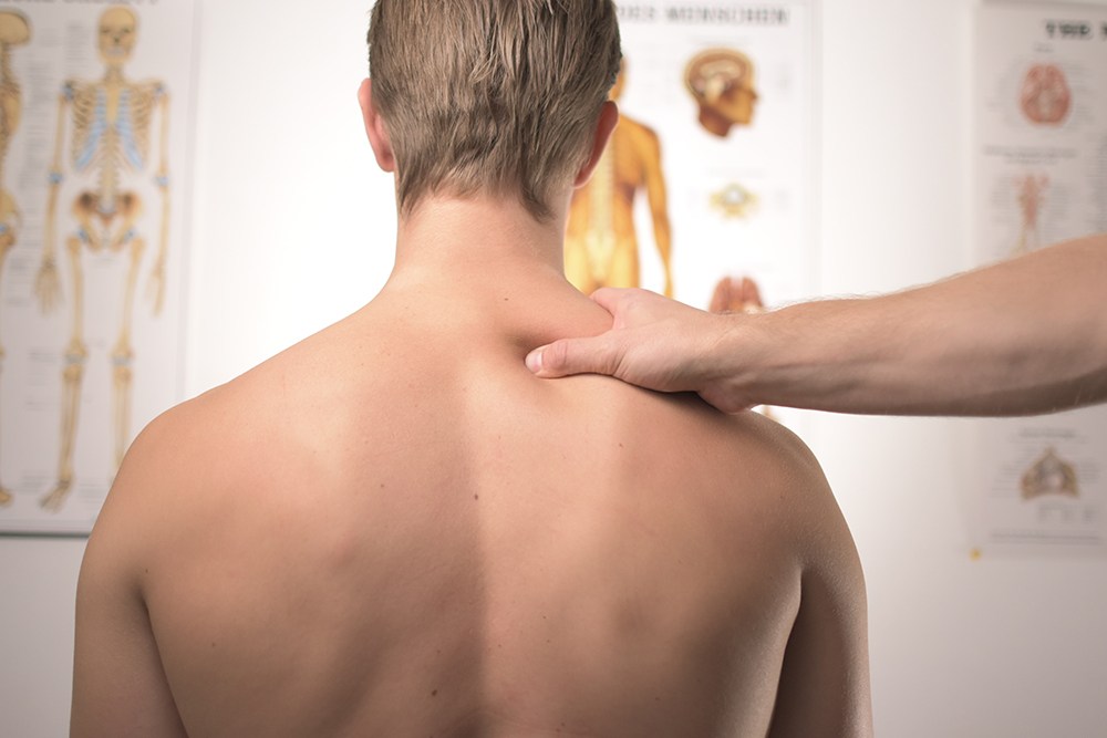 masseuse performing neck and shoulder massage
