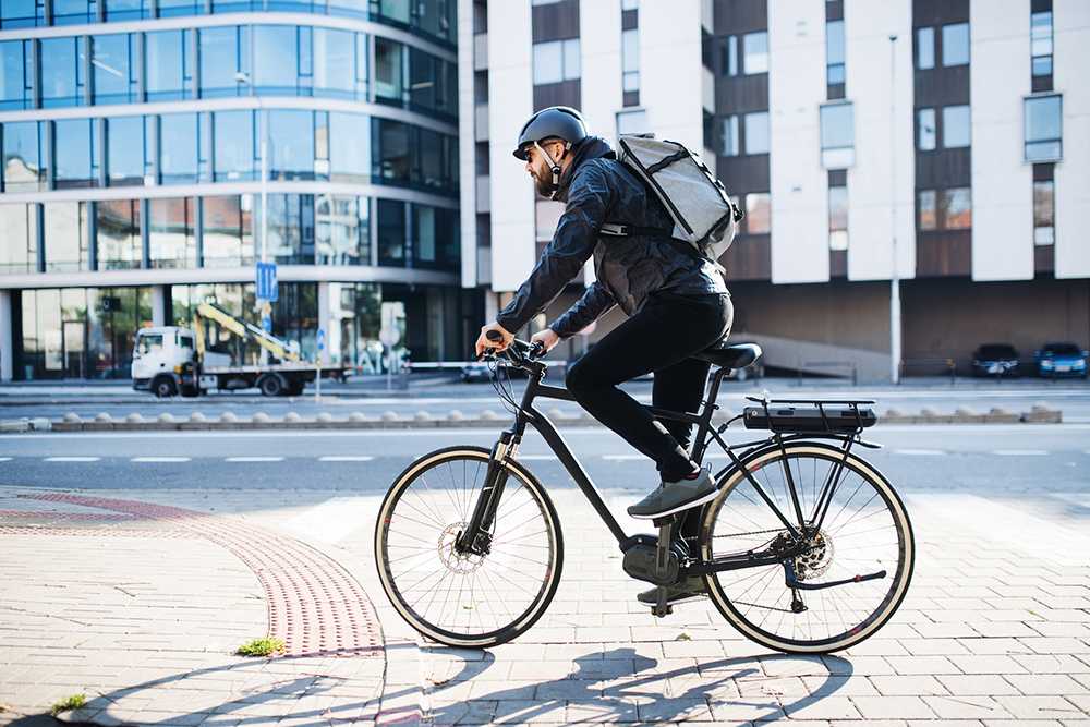 a man riding a black bicycle