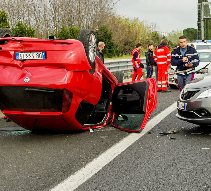 Red car turned upside down due to a crash
