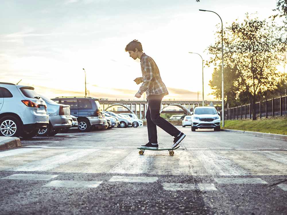 A guy on a skateboard learning to avoid skateboard accidents.