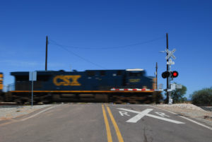 Diesel locomotive passing through a railroad crossing