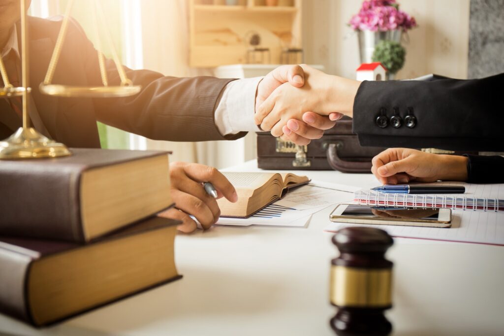 Lawyer and client shaking hands.